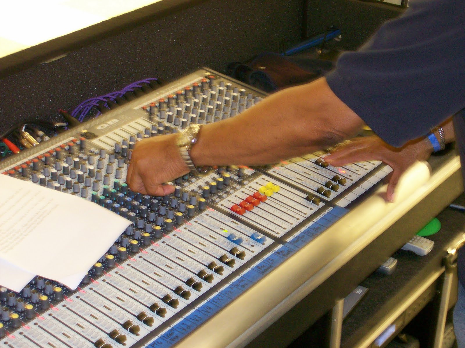 He's always in the DJ booth, but he's not DJing... yup, it-s the sound engineer, a vital part of any good night in many clubs. Pic from: http://schoolmusicmatters.blogspot.com/